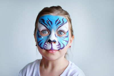 Girl aqua makeup in the form of a blue water tiger zodiac on a white background.