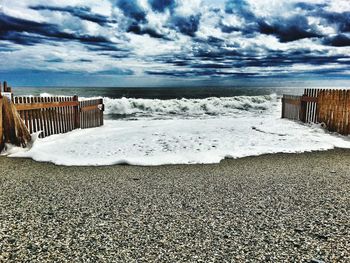 Scenic view of sea against cloudy sky