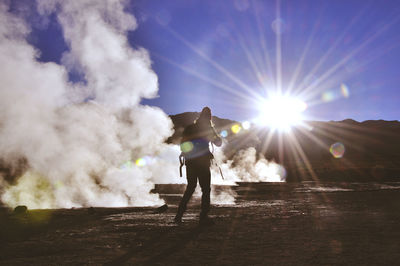 Rear view of silhouette person standing on mountain