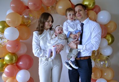 Young family celebrating christening of little baby girl