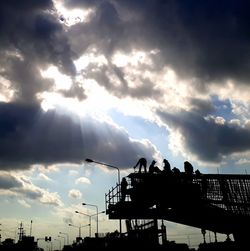 Silhouette people standing against sky