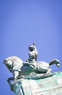 Low angle view of statue against blue sky