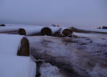 Snow covered landscape against sky