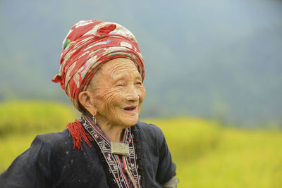 Portrait of smiling woman against blurred background