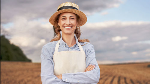 Portrait of smiling young man standing in field