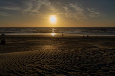 Scenic view of beach against sky during sunset