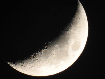 Low angle view of moon in the dark
