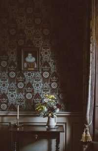 Flower pot against wall at home