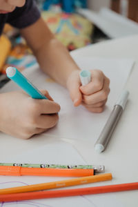 The boy draws with felt-tip pens. high quality photo