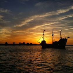 Sailboat in sea at sunset