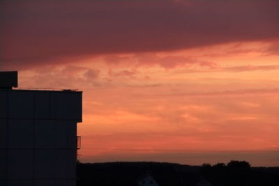 Silhouette city against sky during sunset