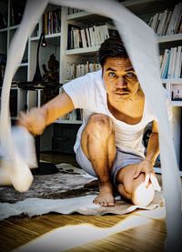 Portrait of young man standing at home