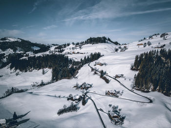 Scenic view of snow covered mountains against sky