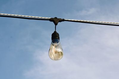 Low angle view of light bulb against sky