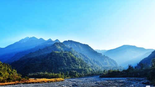 Scenic view of mountains against clear blue sky