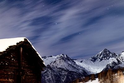 Scenic view of snowcapped mountains against sky at night