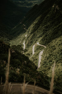 High angle view of road amidst trees and mountains