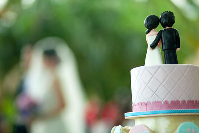 Close-up of wedding cake figurine