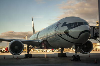 Airplane on runway against sky