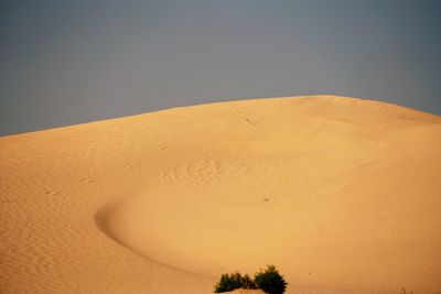 Scenic view of desert against clear sky