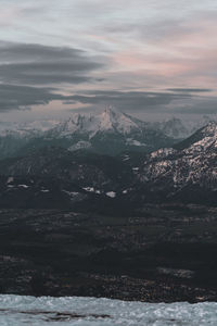 Aerial view of snowcapped mountains against sky during winter