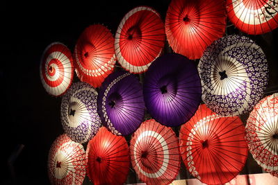 Illuminated umbrella hanging at market stall