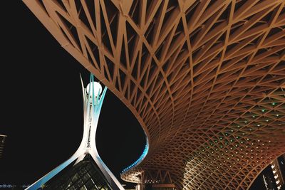 Low angle view of bridge against sky at night