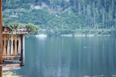 Scenic view of lake by trees against building