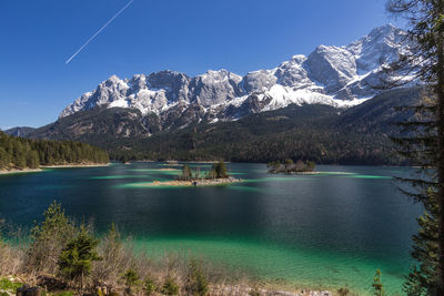 Scenic view of lake and snowcapped mountains against sky