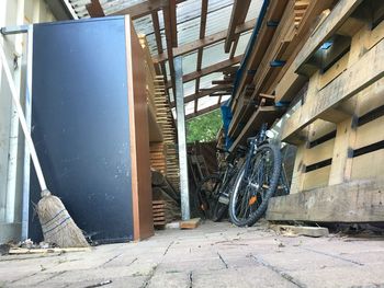 Bicycle parked on street amidst buildings in city