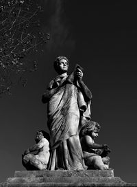 Low angle view of statue against sky