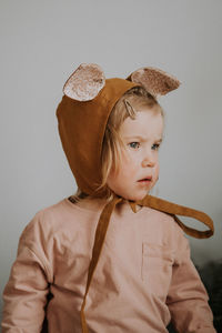 Toddler baby girl in funny hat with ears having fun