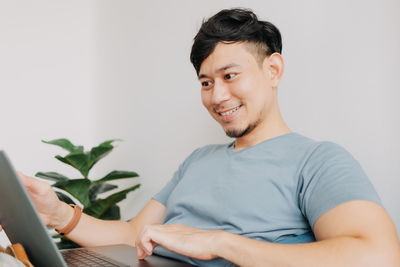 Portrait of young man using mobile phone