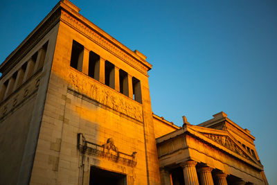 Low angle view of building against clear blue sky, königsplatz 