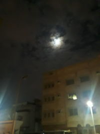 Low angle view of illuminated building against sky at night