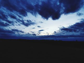 Scenic view of dramatic sky over silhouette landscape