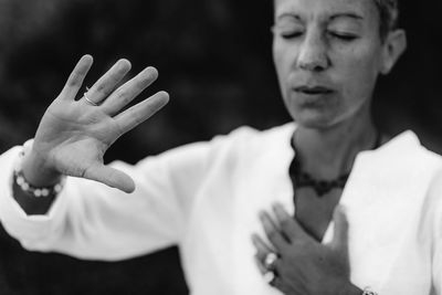 Spiritual coach sending positive thoughts hand gesture