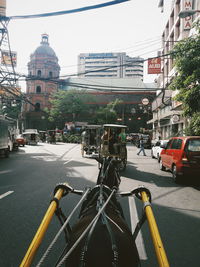 City street and buildings against sky