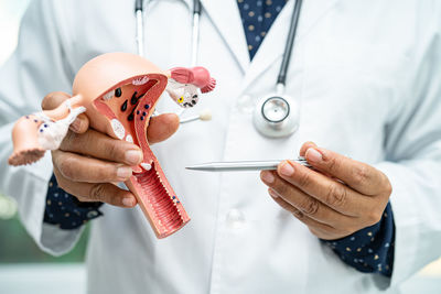 Midsection of doctor examining patient