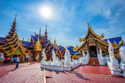 Group of people outside temple against building