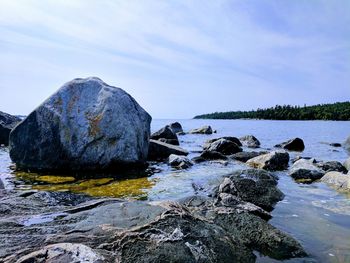 Rocks in sea against sky