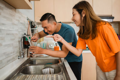 Side view of woman preparing food at home