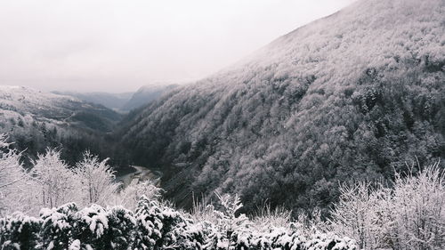 Scenic view of snow covered mountains against sky