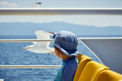 Man in boat on sea against sky