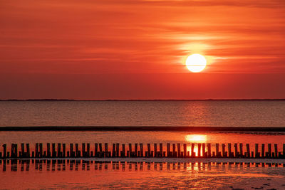 Scenic view of sea against orange sky during sunset