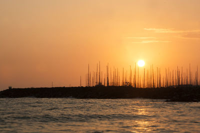 Scenic view of sea against orange sky