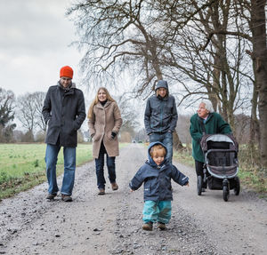 Family walking on footpath during winter