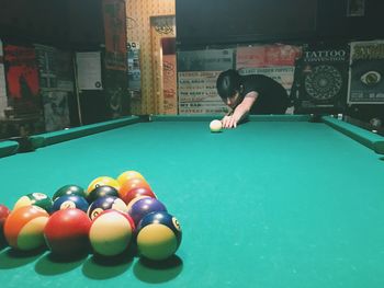 Young woman playing pool