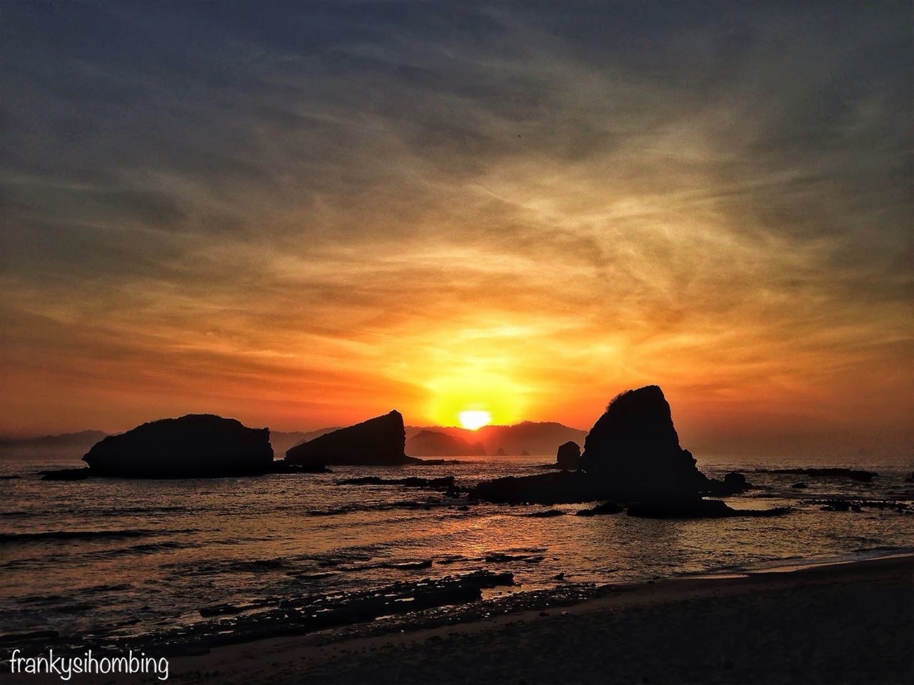 sea, sunset, water, scenics, horizon over water, beauty in nature, tranquil scene, orange color, beach, sky, tranquility, shore, rock - object, idyllic, nature, sun, rock formation, cloud - sky, silhouette, coastline