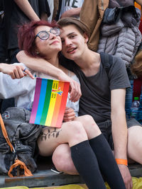 Young couple sitting outdoors